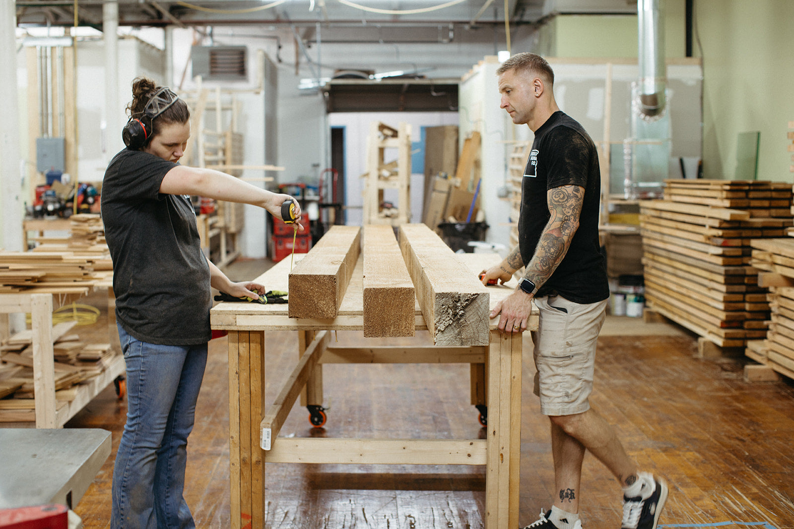 Hamish and Molly measuring cedar at the workbench