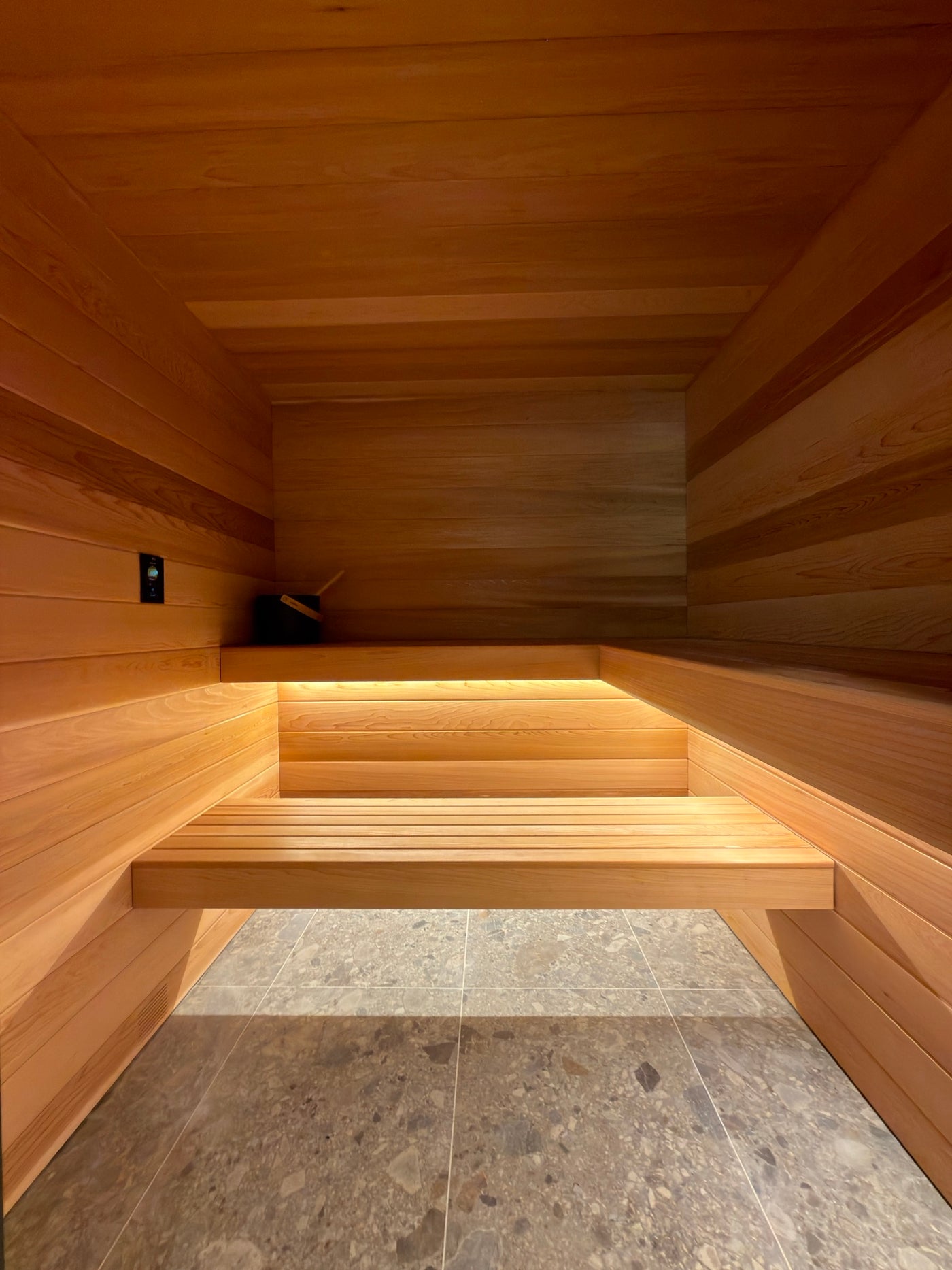 A Verdure built-in sauna with a floating cedar bench lit from beneath