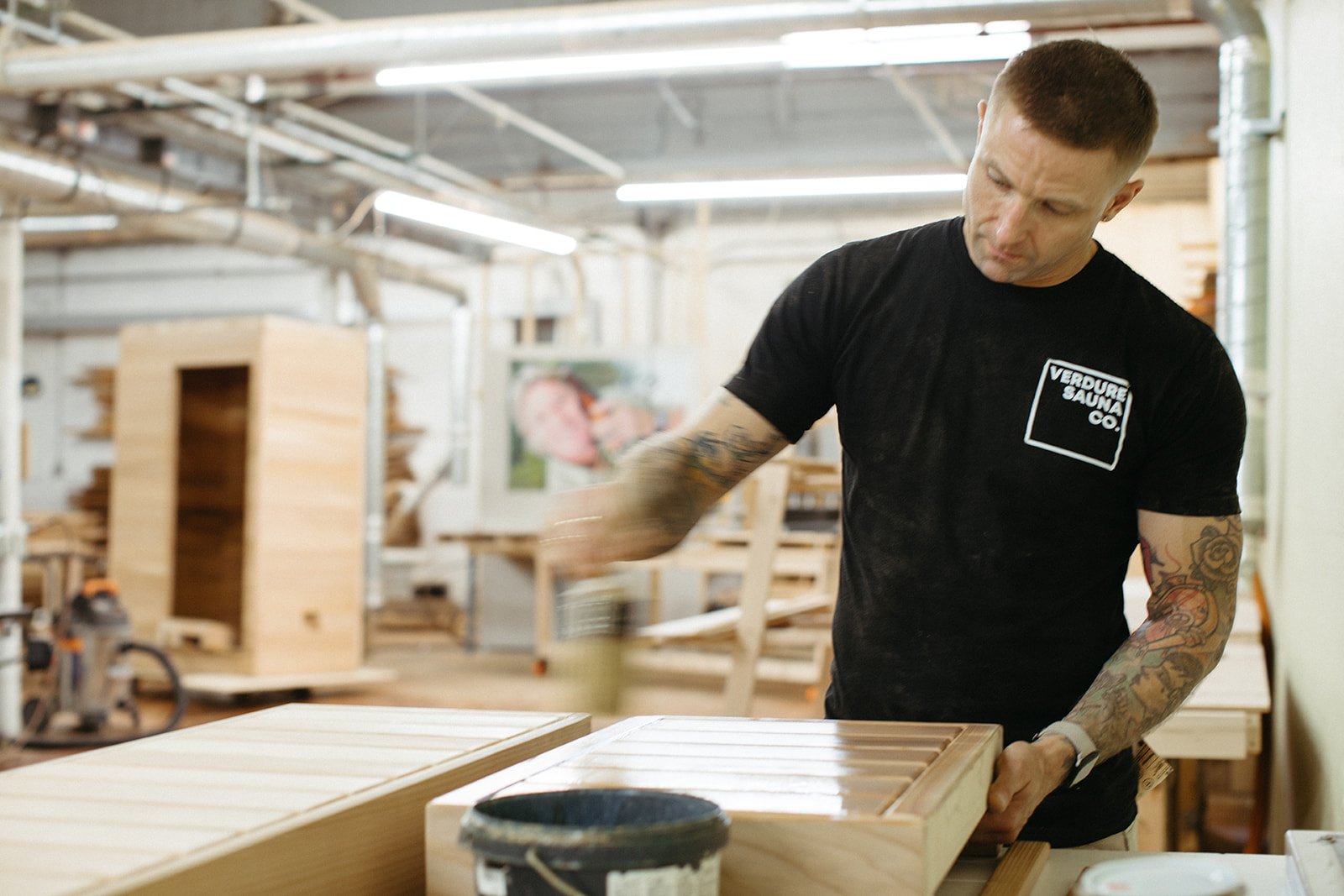 Hamish finishing a cedar bench in the workshop
