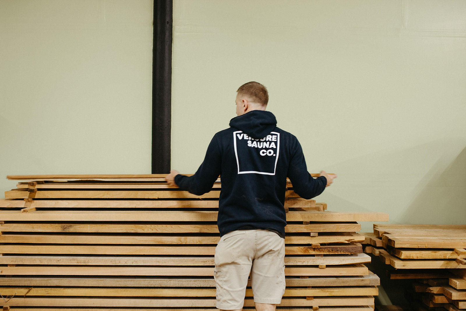 Choosing boards from the rough cedar stack in the workshop